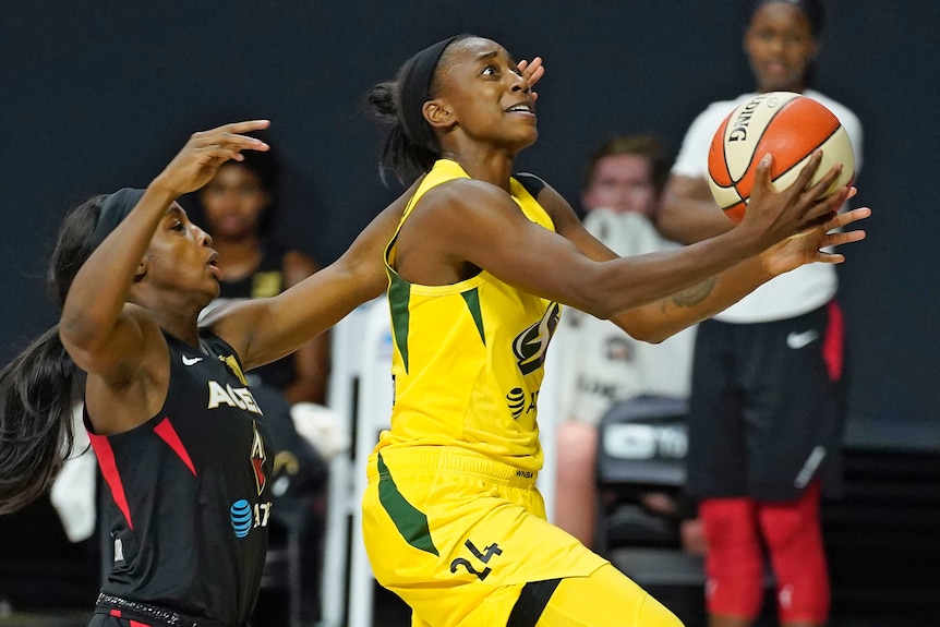 A Seattle Storm WNBA player drives for a basket during the WNBA Finals Game Three against Las Vegas Aces.