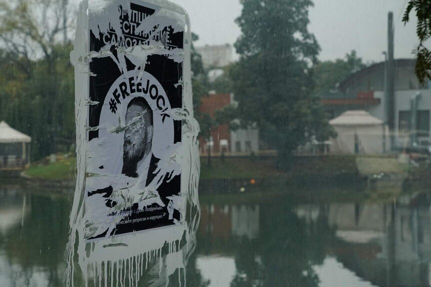 A poster that has ben defaced with white paint