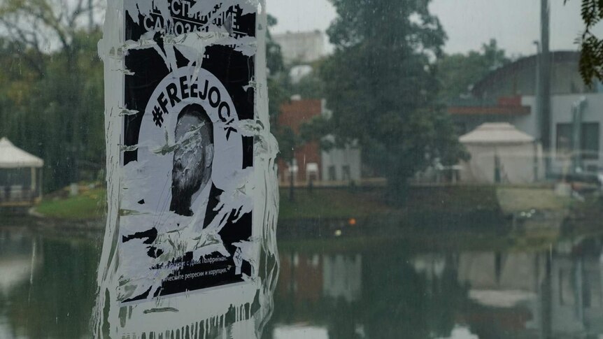 A poster that has ben defaced with white paint