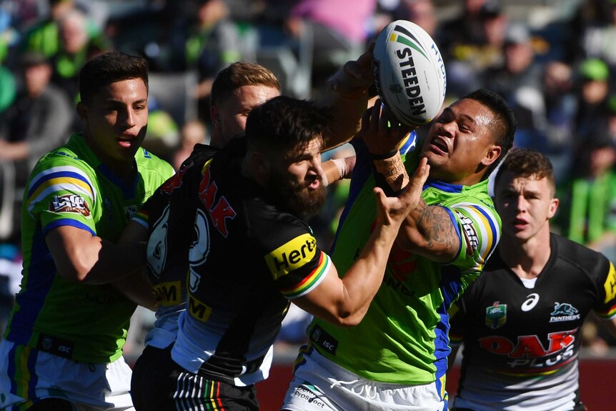 Josh Mansour and Joey Leilua fight for the ball