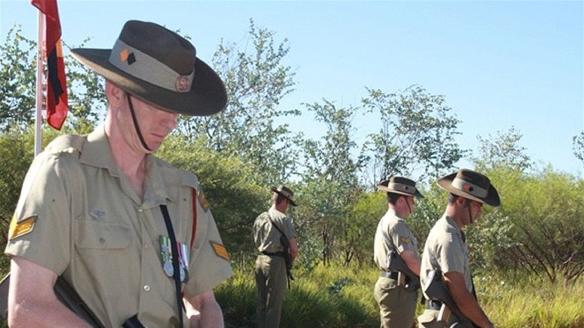 Servicemen stand watch during the service at Whim Creek.