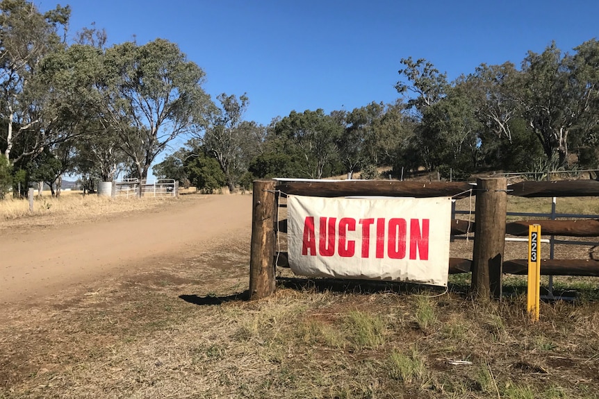 An auction sign hangs on a gate at the McCreath's old property in Felton.