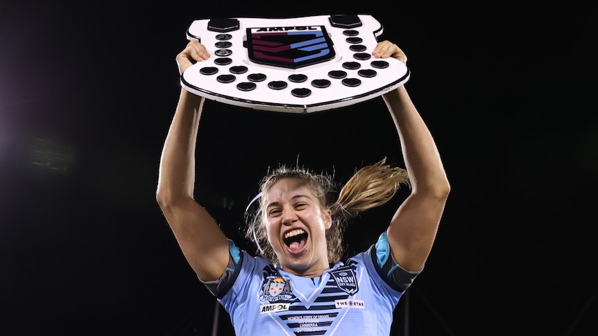 NSW Sky Blues captain Kezie Apps holds up the Women's State of Origin shield.