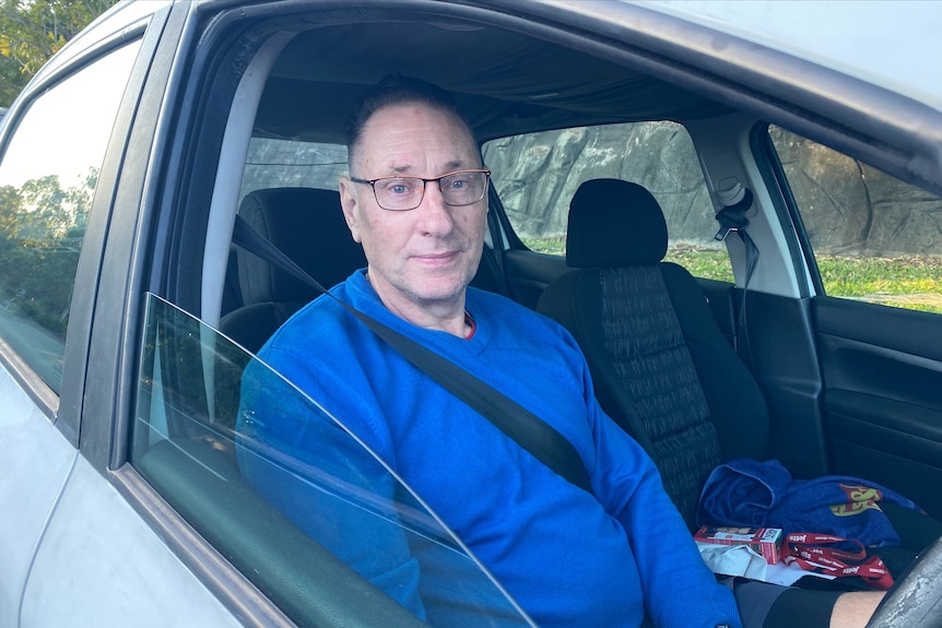 Nerang resident Gregg Guyder in his car.