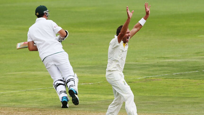 Australia's Ryan Harris takes the wicket of Graeme Smith against South Africa in Port Elizabeth.