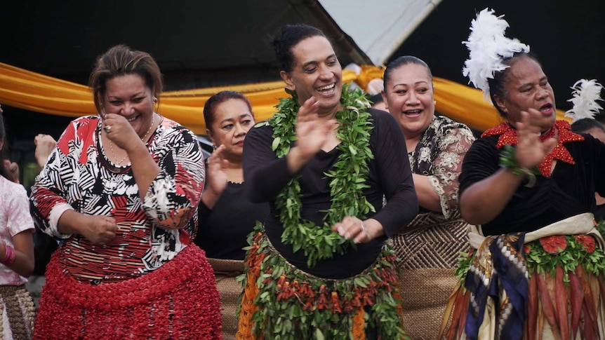 A group of Leitis dance wearing traditional skirts