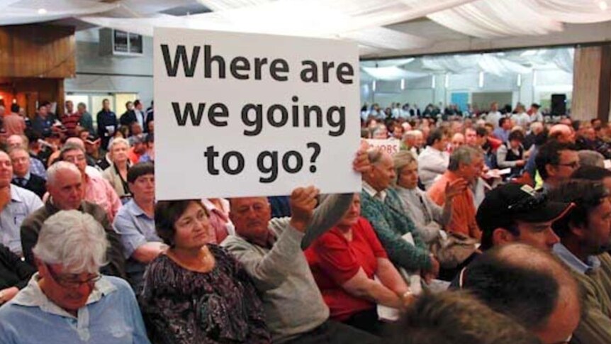 A man holds up a sign during a protest meeting in Griffith. (Brett Naseby)