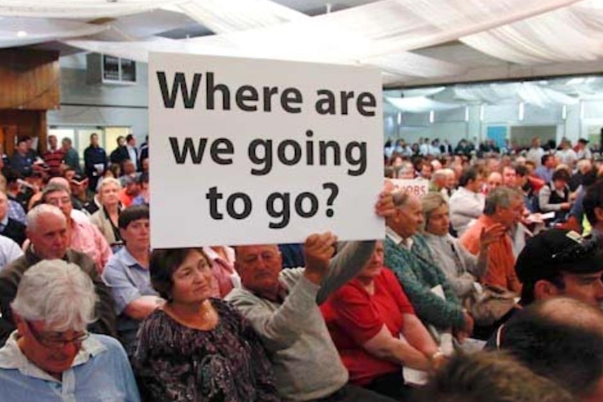 A man holds up a sign during a protest meeting in Griffith. (Brett Naseby)