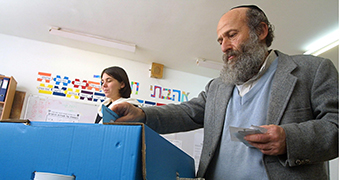 A Jewish settler casts his ballot at a polling station in the West Bank settlement of Efrat.