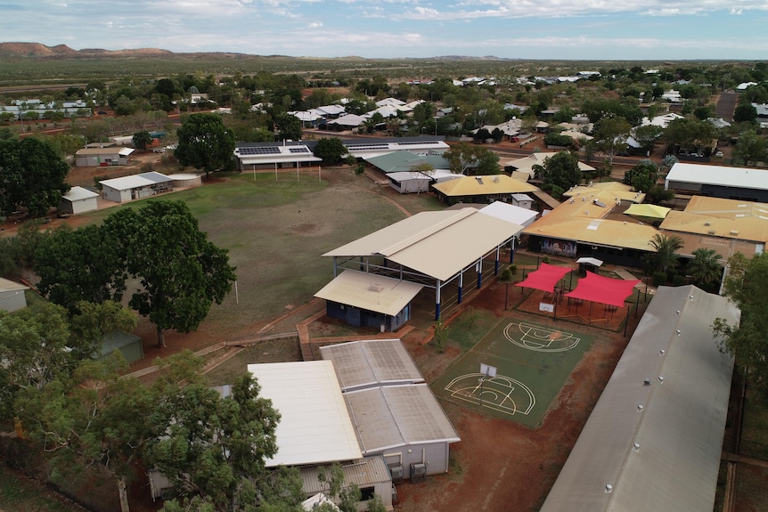 Aerial view of school buildings and grounds in remote town