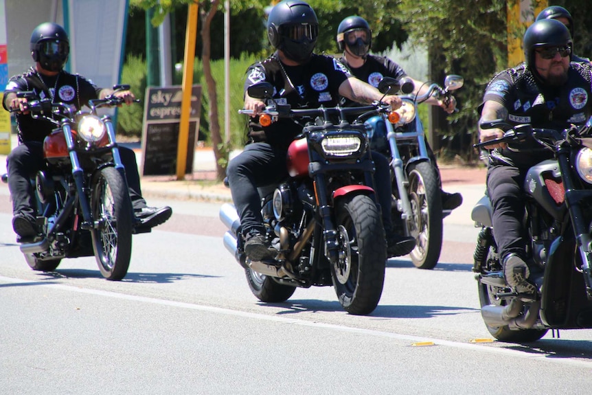 Rebels bikies ride their motorcycles along Scarborough Beach Road.