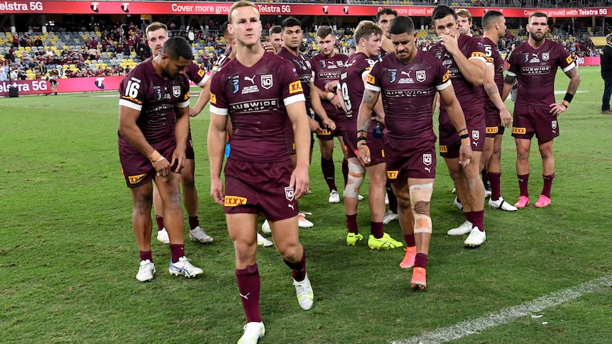 Daly Cherry-Evans looks disappointed with the Maroons team behind him