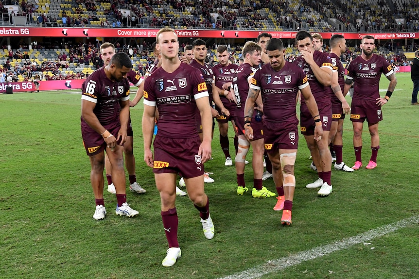 Daly Cherry-Evans looks disappointed with the Maroons team behind him