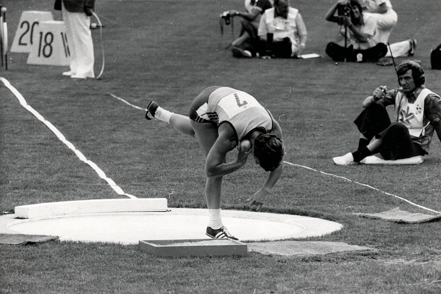 Bev Francis prepares to throw a shotput.