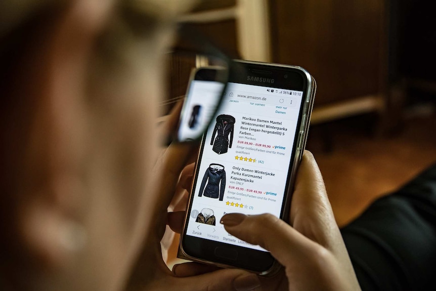 A woman looking at shopping on her mobile phone