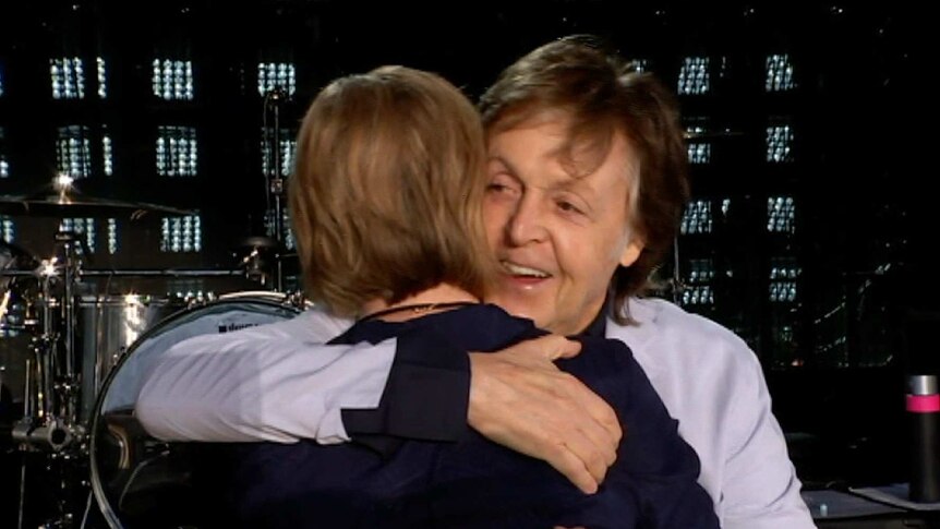 Paul McCartney hugs Leigh Sales at the end of the interview