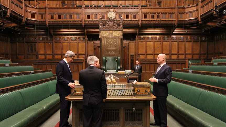 Mr Kerry stands on one side of the house, Mr Hague on the other, and Mr Bercow in between