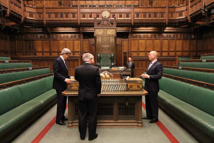 Mr Kerry stands on one side of the house, Mr Hague on the other, and Mr Bercow in between