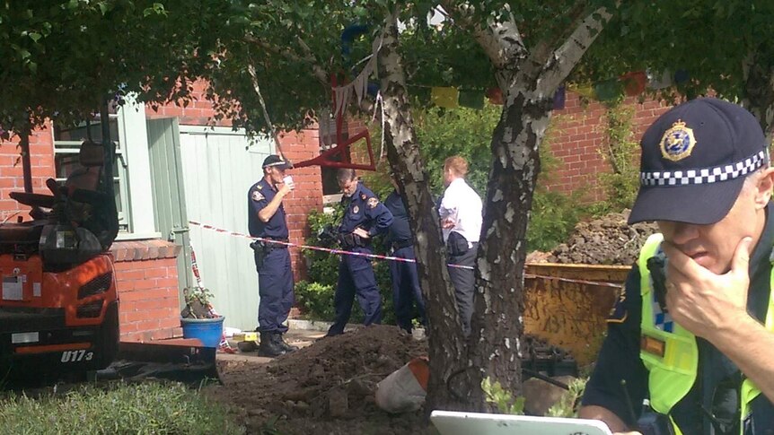 Police excavate a front year in West Hobart