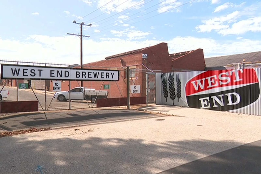 An industrial site with a sign saying West End brewery