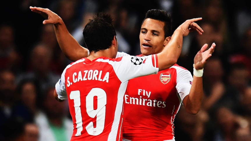 Alexis Sanchez and Santi Cazorla celebrate an Arsenal goal
