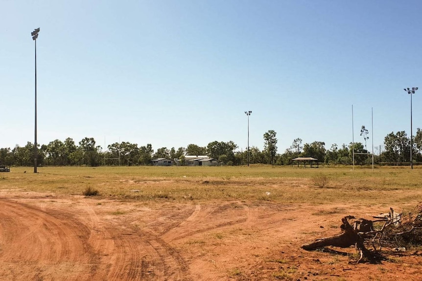The Doomadgee football field, showing clear tyre marks and uneven grass.