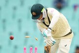 Australia batsman Peter Handscomb plays a shot as a cricket ball hits his stumps on day four of the SCG Test against India.
