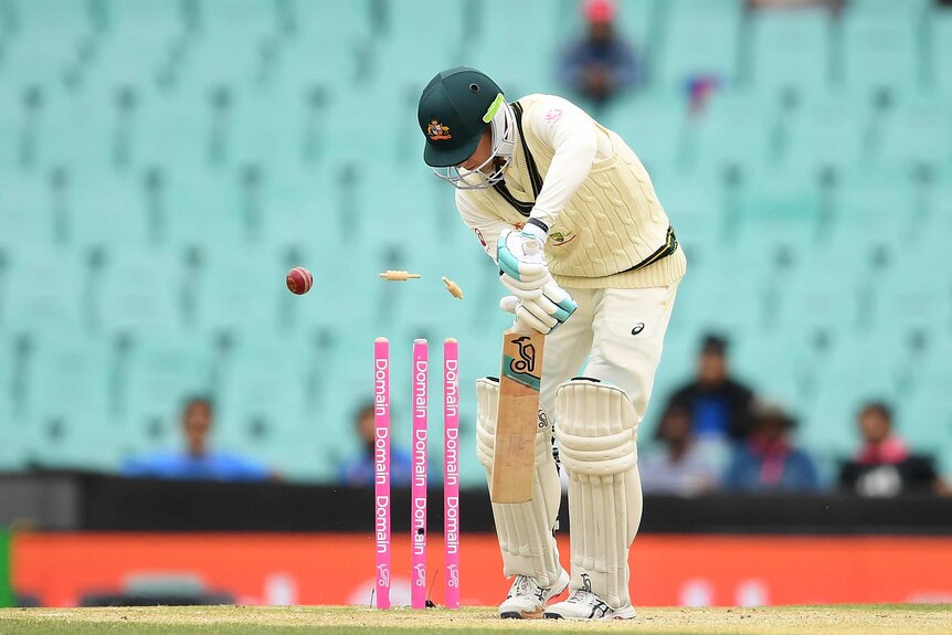 Australia batsman Peter Handscomb plays a shot as a cricket ball hits his stumps during a Test against India at the SCG.