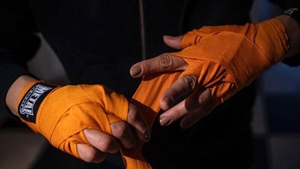 Sadaf Khadem binds her hands in orange tape