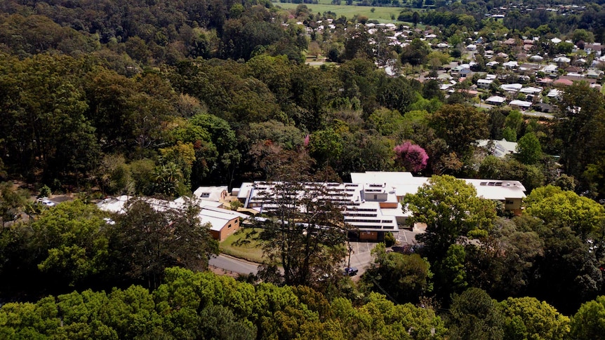 A drone shot shows the aerial view of the hospital building.