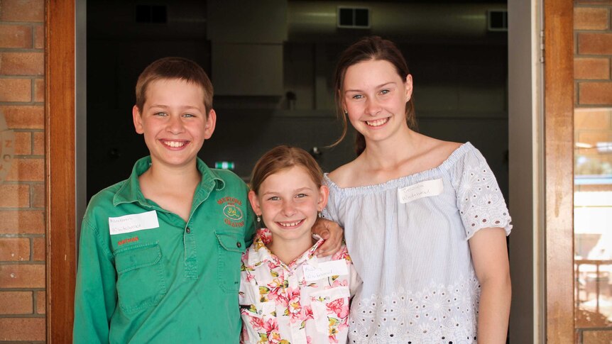 Nathan, 11, Ashley, 9,  and 12-year-old Jessica Whitehead smiling at the camera at the book launch.