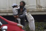 Leidy and her two-year-old son Leiton wave a white flag on la carretera al Pacifico in Villa Nueva, Guatemala, on 6 May 2020.