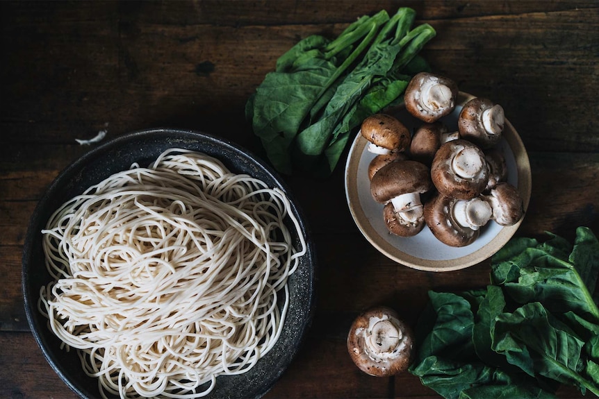 Ingredients for vegan dan dan noodles including fresh noodles, swiss brown mushrooms and Chinese broccoli, for Lunar New Year.