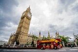 Big Ben in London as a sightseeing bus drives past it
