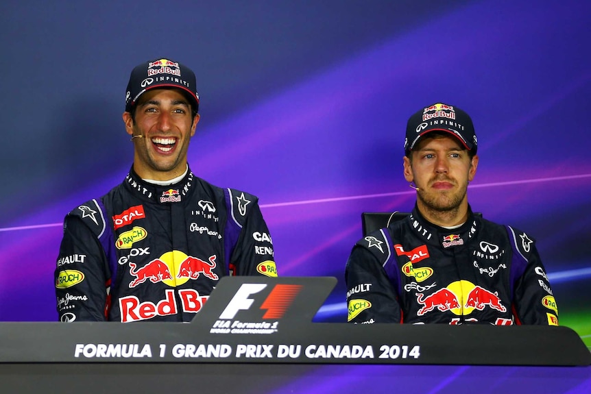 Daniel Ricciardo smiles as Sebastian Vettel looks on