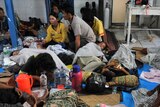 Wounded survivors receive medical treatment at a local hospital in the village of Sikakap on North Pagai island.