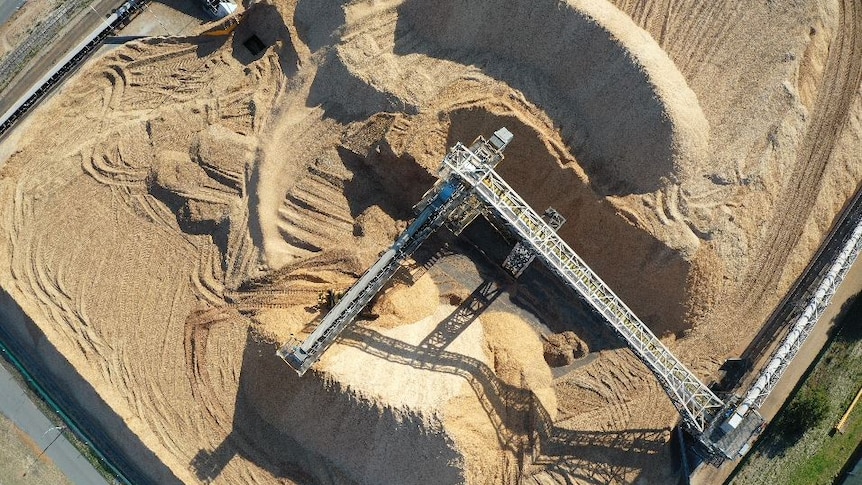 A drone shot showing a massive pile of woodchips.