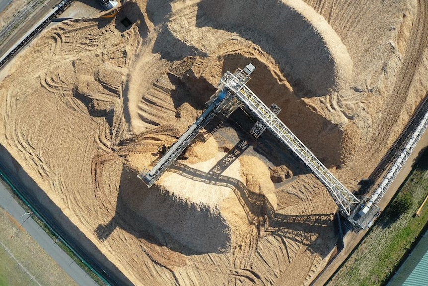 A drone shot showing a massive pile of woodchips.