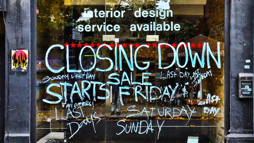 The exterior of a vacant shopfront with 'Closing Down' painted on it.