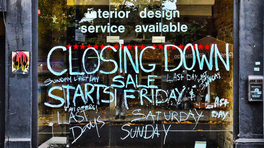 The exterior of a vacant shopfront with Closing Down painted on it.