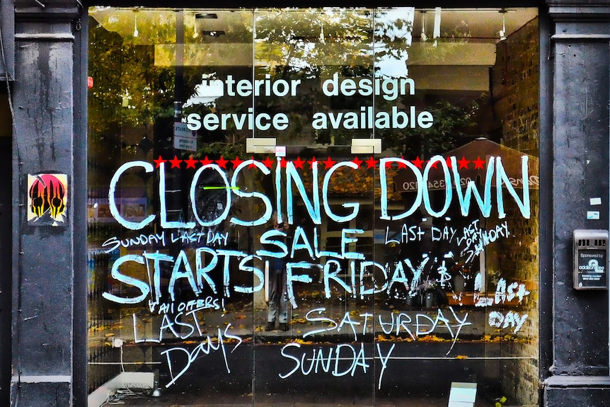 The exterior of a vacant shopfront with Closing Down painted on it.