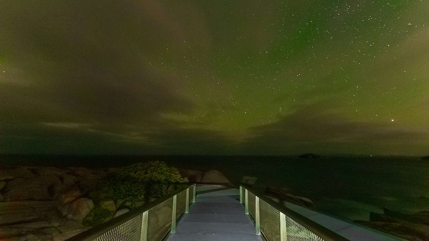 The green and pink aurora australis taken from The Gap platform near Albany in southern WA