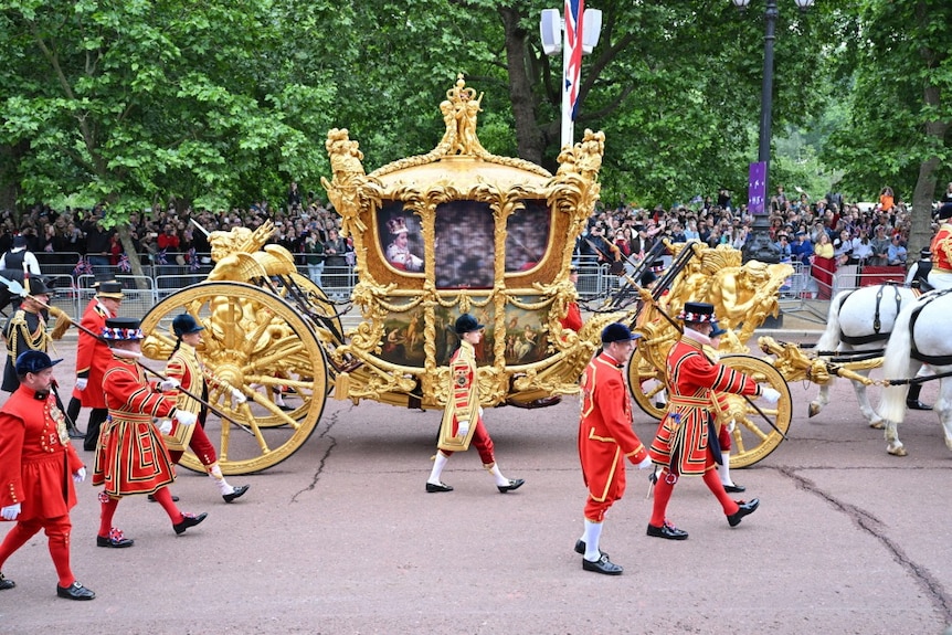A hologram of the queen seen on the windows of the Gold State Coach during a parade. 
