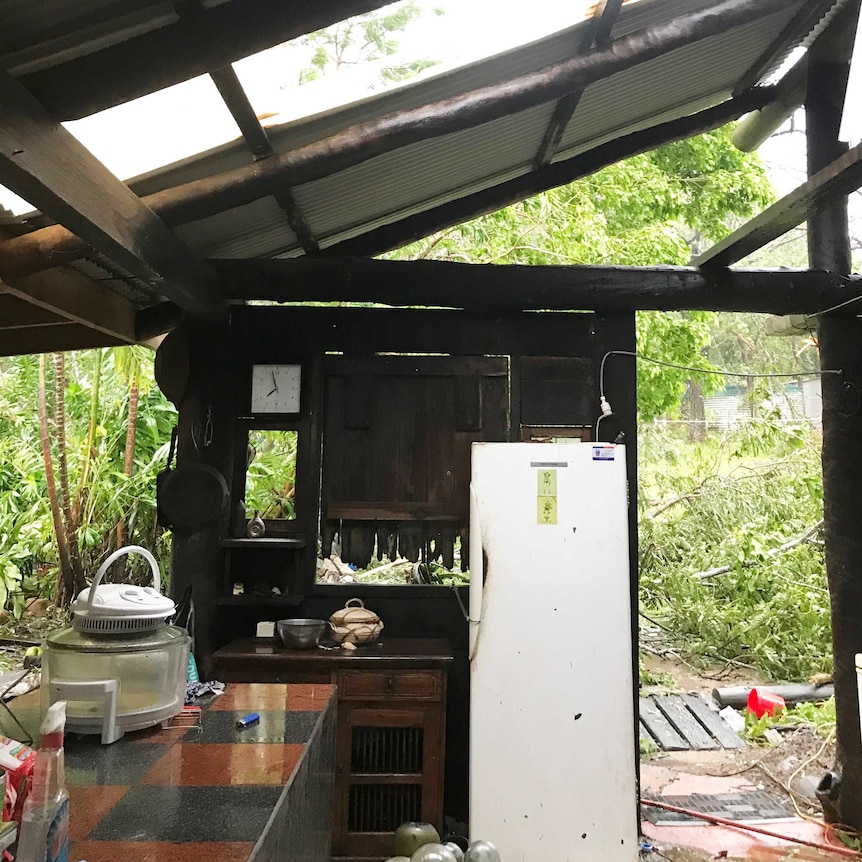 Inside of a kitchen showing missing walls and roofing after the cyclone.