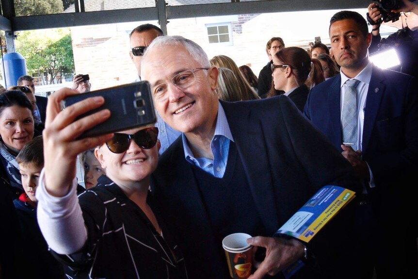 Turnbull takes a selfie with a voter at a polling booth, July 2, 2016