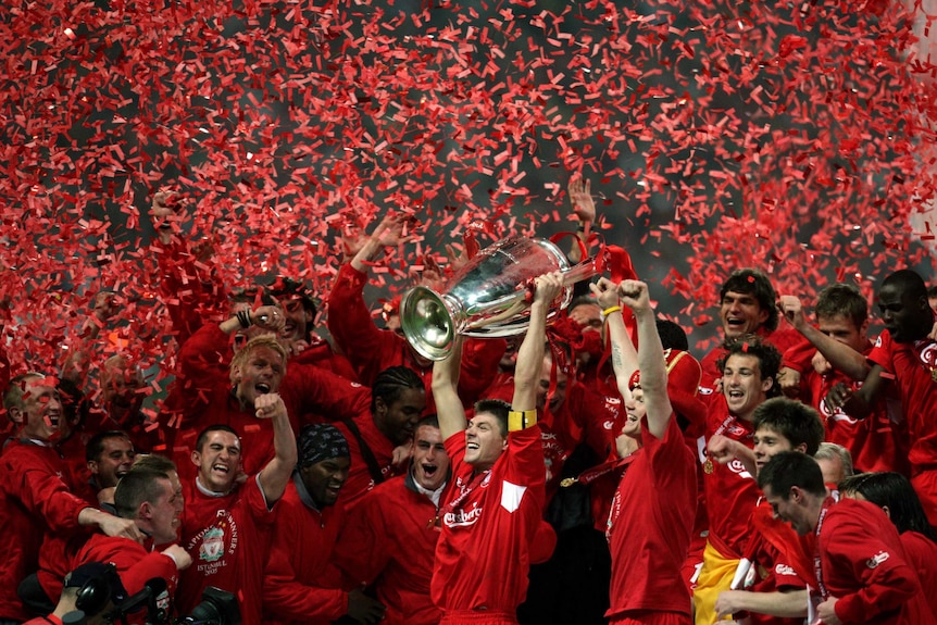 The Liverpool captain hoists the Champions League trophy as his teammates are covered in confetti.