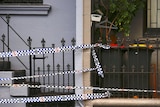 Lines of police tape stretch across the entrance to a home in Sydney.