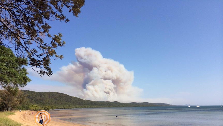 Smoke can be seen from the beach on North Stradbroke Island