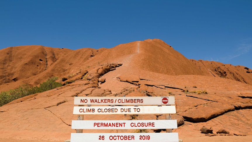 A "Permanent closure" sign at the base of Uluru.