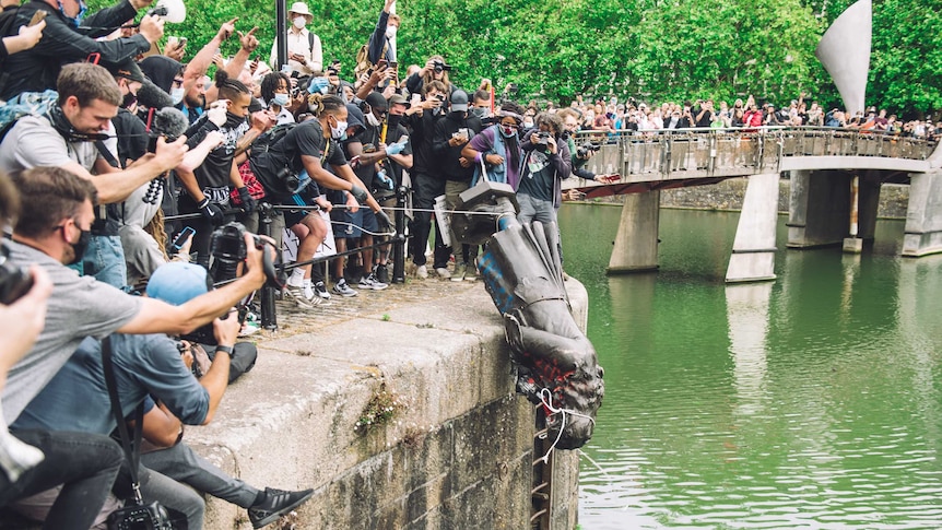 The statue of late 17th century slave trader Edward Colston is pushed into the river Avon - Bristol, England, June 7 2020
